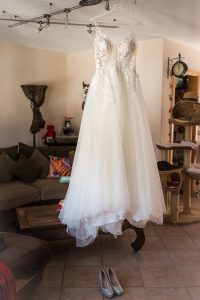 Das Hochzeitskleid und die Schuhe der Braut hängen bereit im Wohnzimmer des Hauses der Brautmutter während der Vorbereitungen in Lahr.